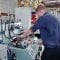 A person wearing blue uniform operating a hydraulic machinery