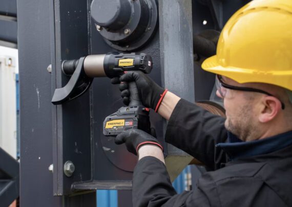 A person using an Enerpac Battery Torque Wrench
